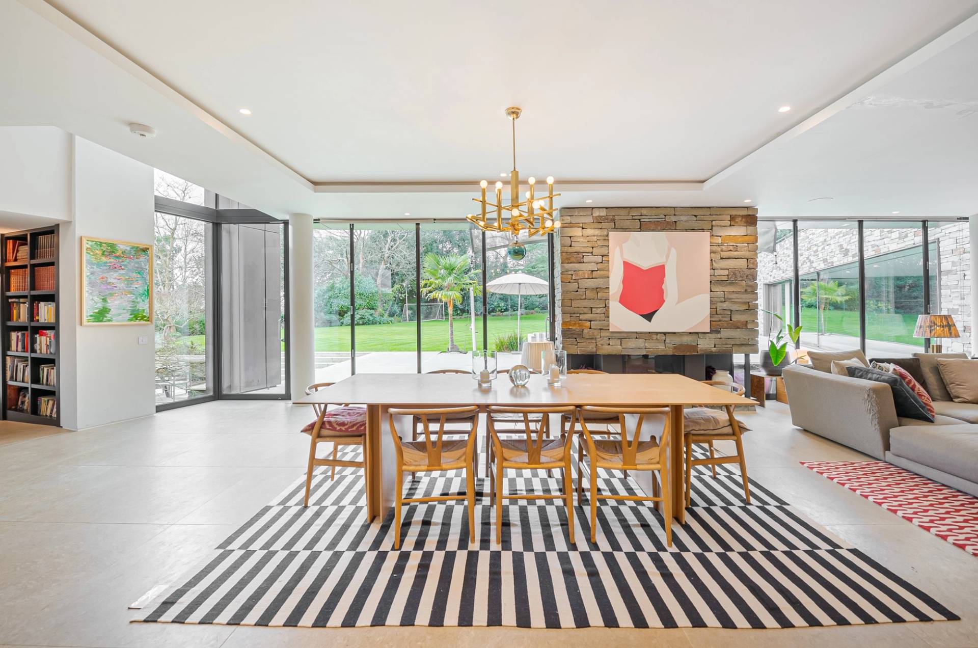Modern dining suite set against a stone feature wall with abstract artwork and striped area rug in Kingston upon Thames, ideal for homeware lookbooks, Love Locations KT2.