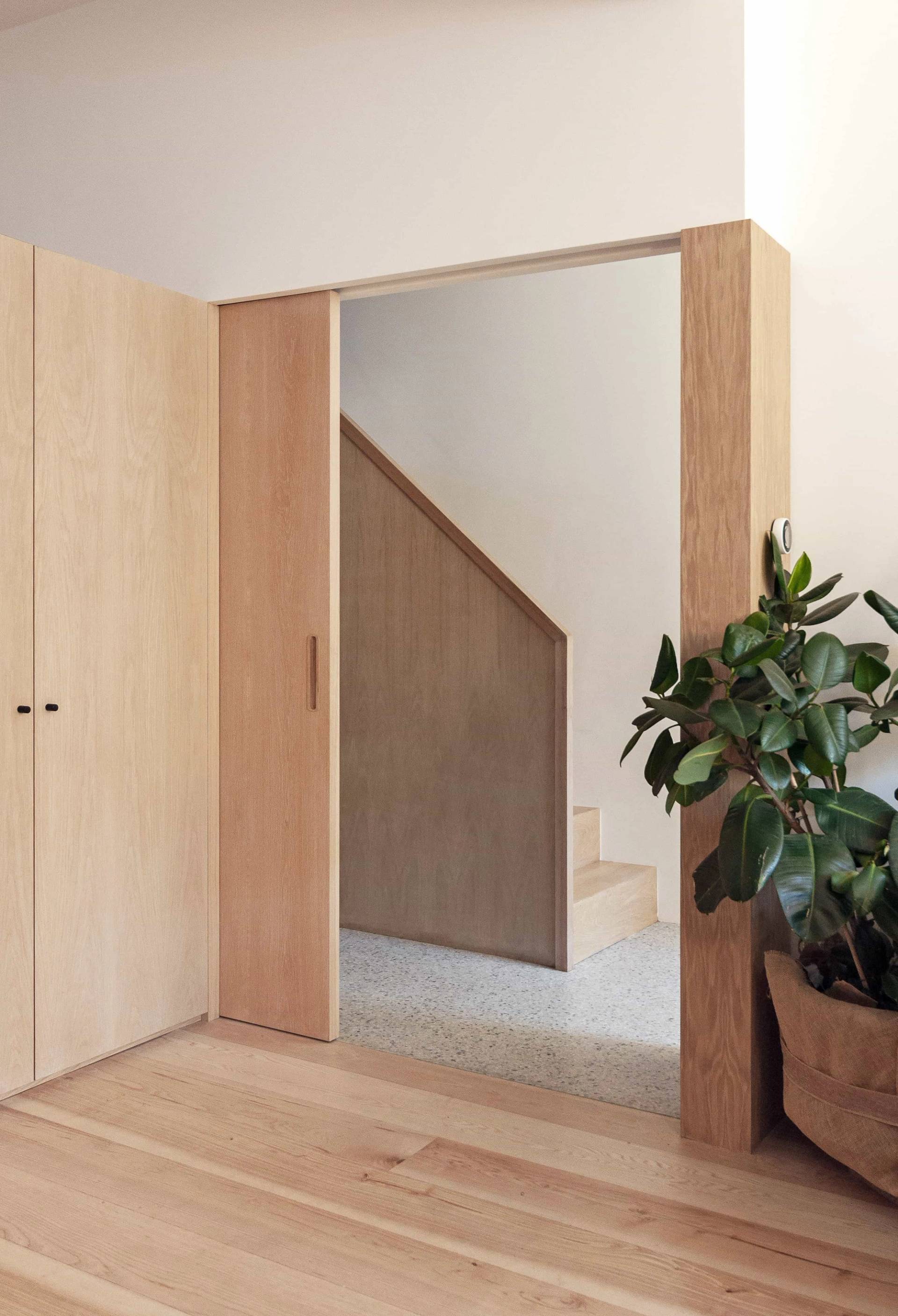 Light wood panelled hallway and hidden doorway shoot location in Hackney N16 by Love Locations, highlighting seamless architectural joinery.