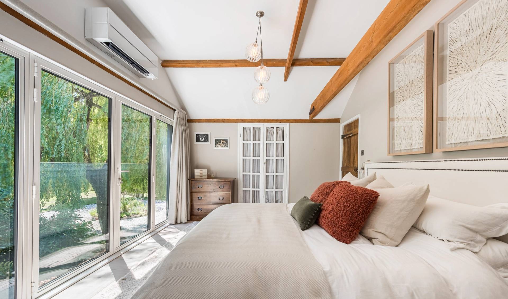 Contemporary bedroom location room featuring sliding glass doors opening out to a private balcony deck, via Love Locations CM3.