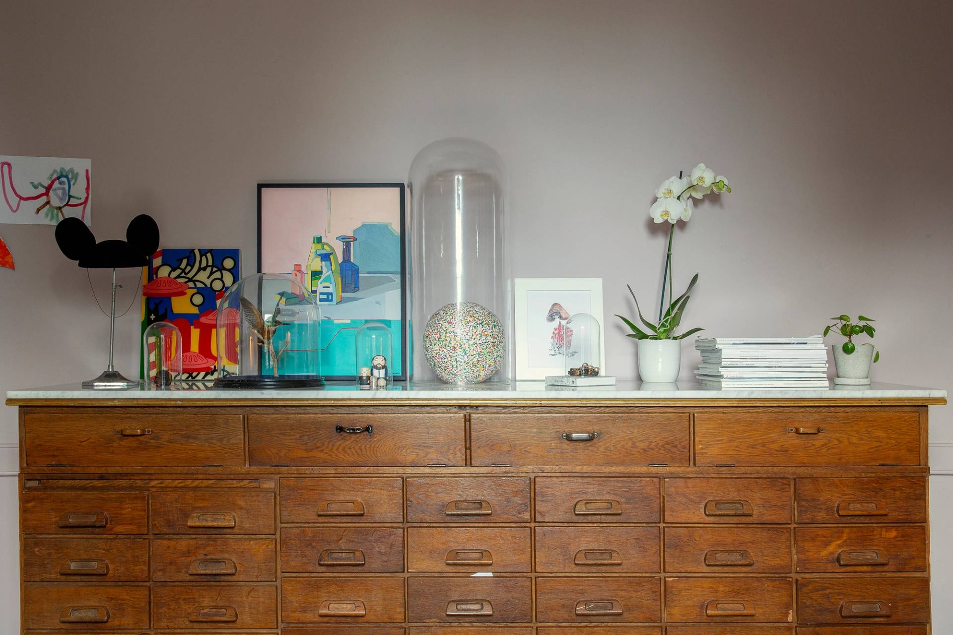 Vintage apothecary cabinet with multiple wooden drawers set against grey painted walls, Love Locations ME13.