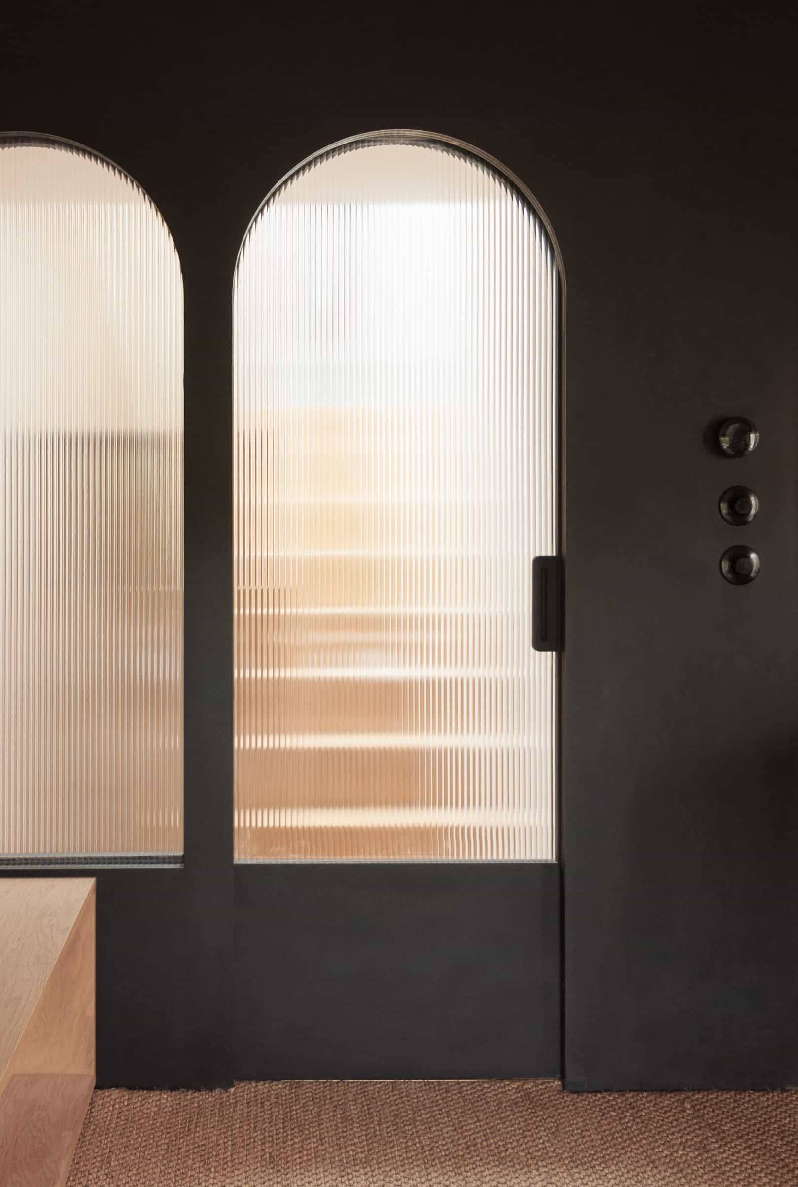 Fluted reeded glass doors and dark timber frame detail in a modern Victorian terrace location house in Hackney N16 by Love Locations.