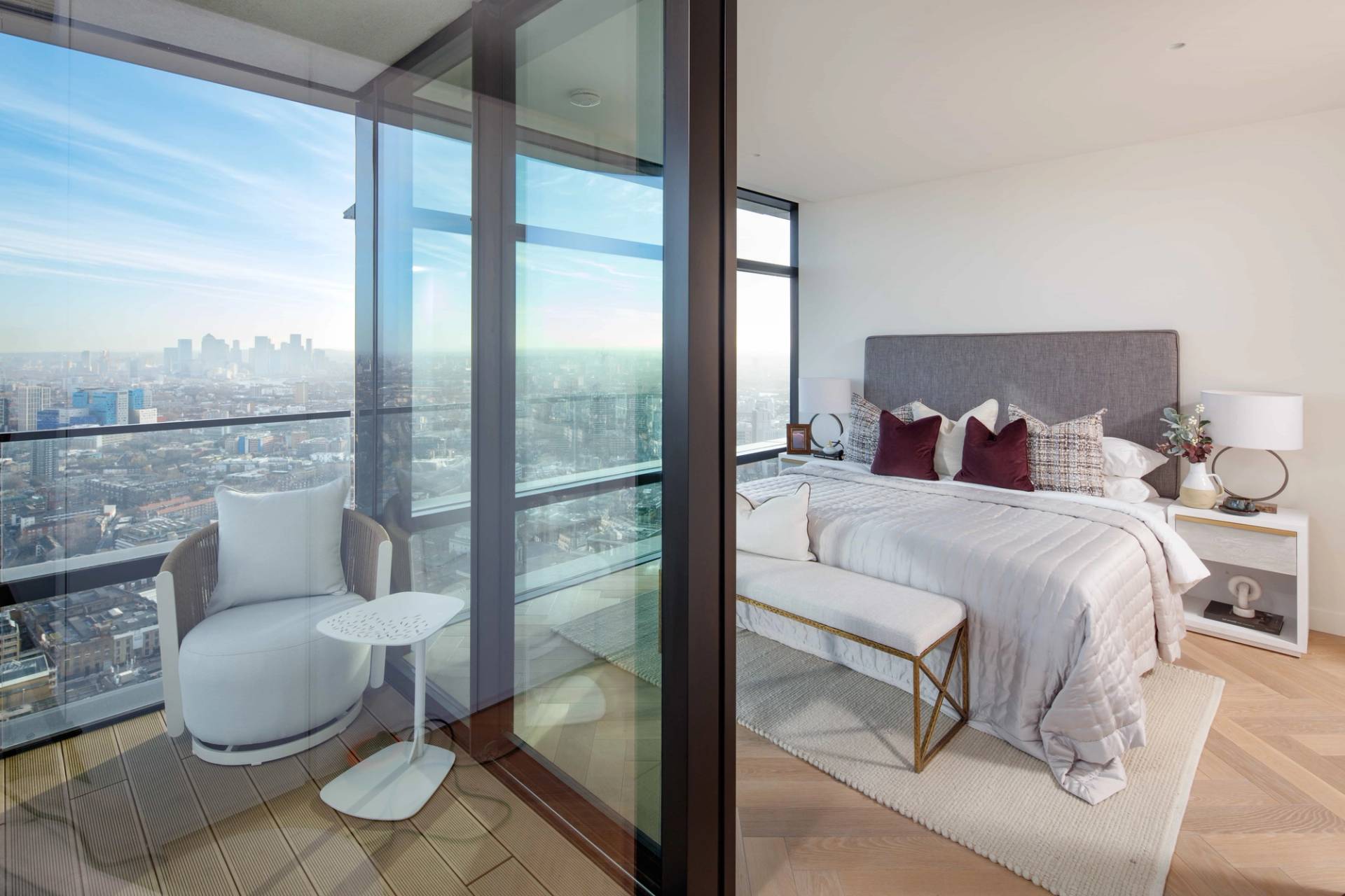 Master bedroom balcony access showing sliding glass doors with direct views over London skyscrapers, perfect for luxury apparel campaigns, Love Locations EC2A.