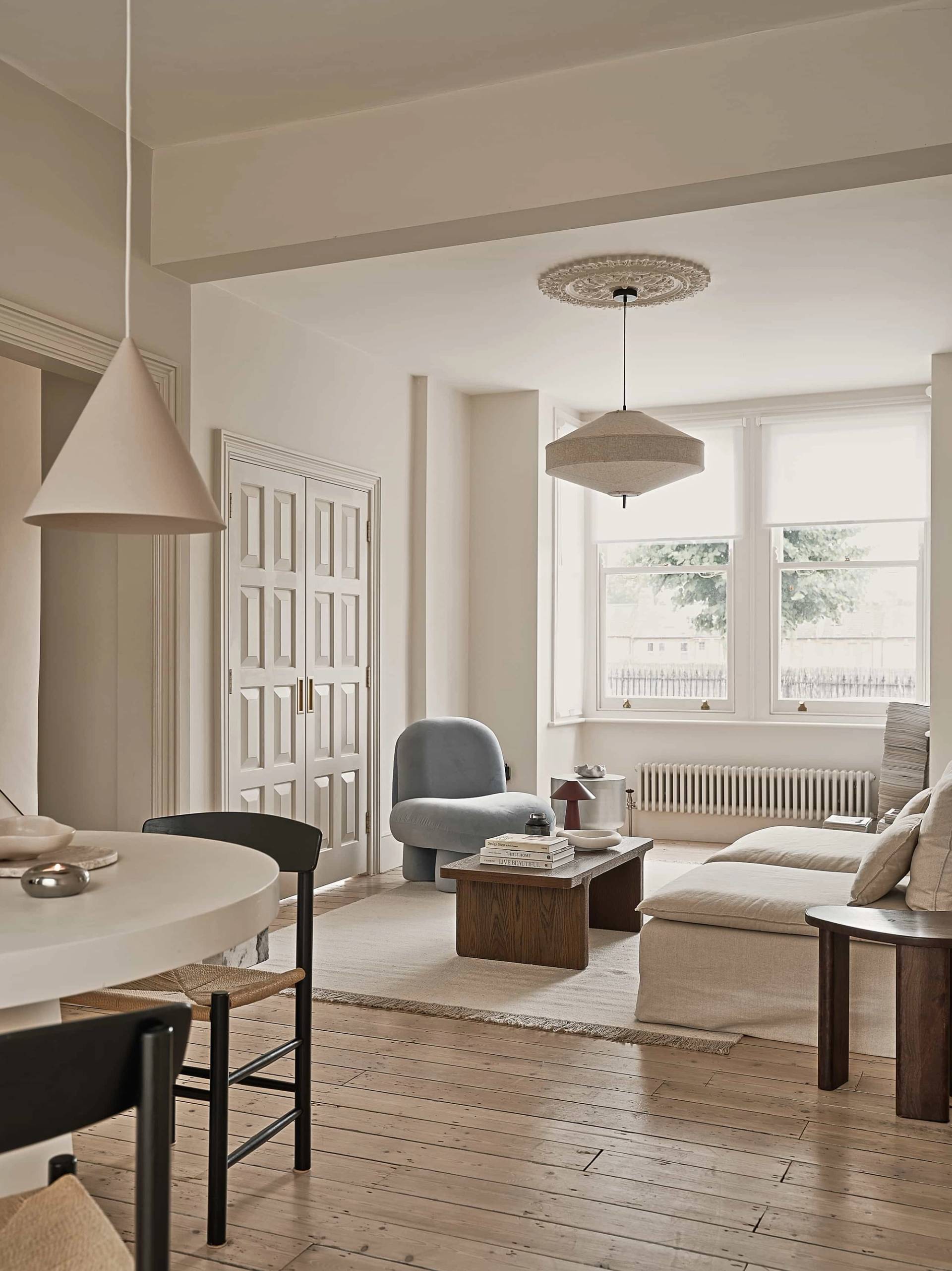 Spacious open-plan neutral living room with cream sofa, dark wood coffee table, and soft beige walls, Love Locations Waltham Forest.