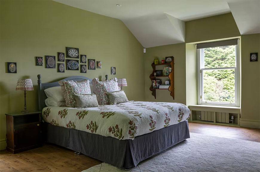 Glenstriven guest bedroom with decorative painted wardrobe panels and soft natural light.