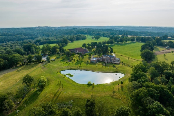 High-angle aerial view of the 170-acre Sussex estate showcasing elevated valley views and private lakes, managed by Love Locations.