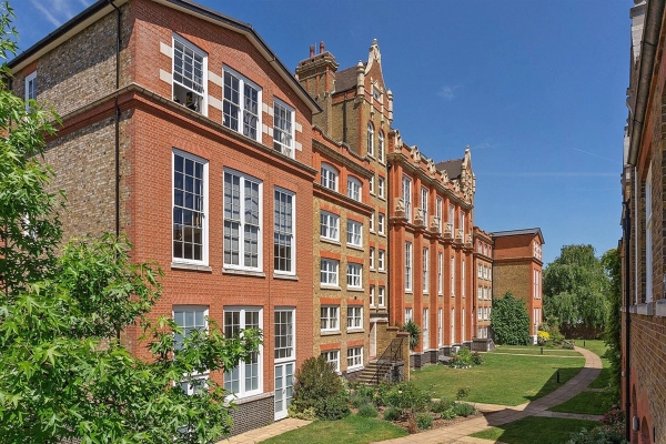 Historic red-brick converted Victorian school exterior film location in Brixton SW4 available through Love Locations, featuring grand tall windows, ornate terracotta masonry, and manicured lawns.