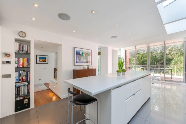 Modern open-plan kitchen looking through to a sunlit living space, suitable for domestic family lifestyle photography, Love Locations London.