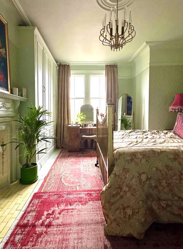 Sunlit bedroom with brass bed frame, pink carpet runner, and large sash windows in Palmers Green, Love Locations N13.