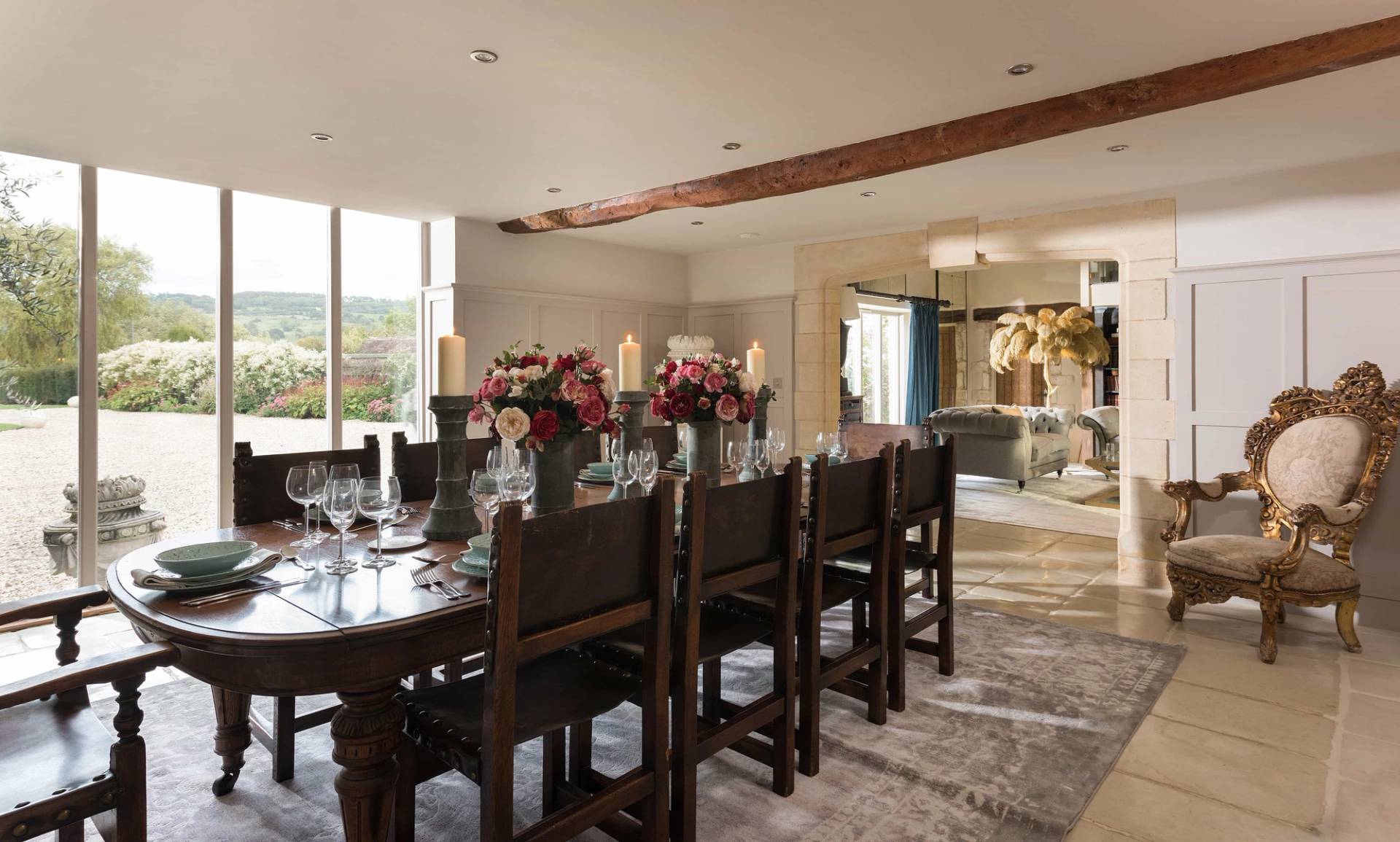 Sprawling open-plan dining and living room film location in Gloucestershire GL51 from Love Locations, highlighting traditional timber beams and rich wood furnishings.