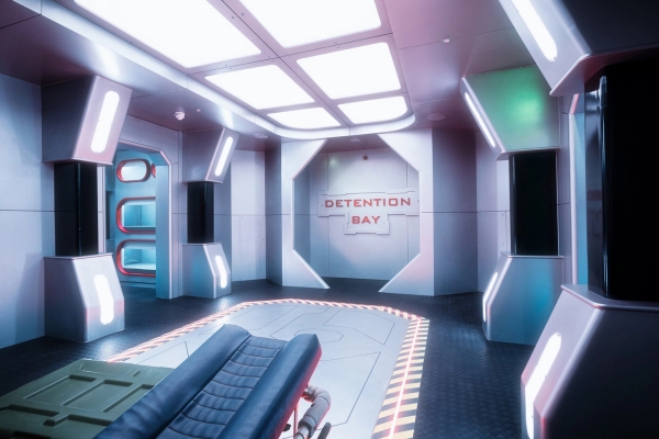 Sci-fi medical bay or spaceship detention cell set complete with a treatment bed and neon lighting accents, Love Locations.