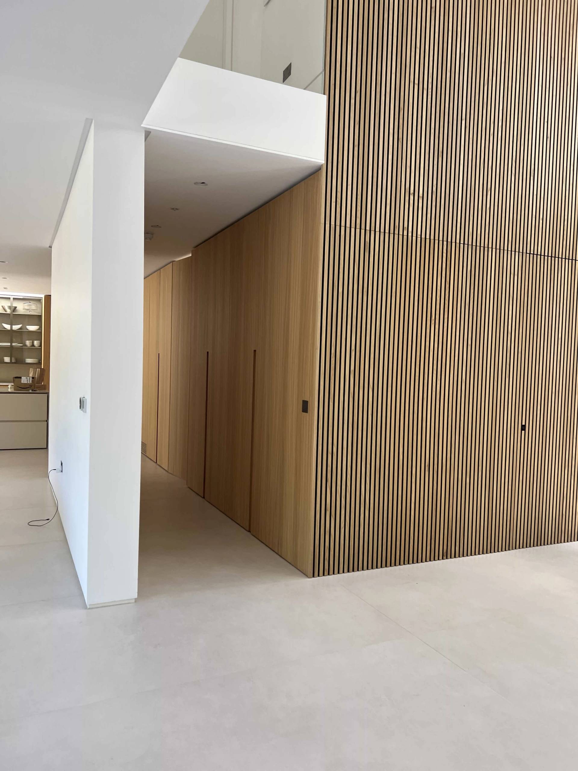 Architectural hallway transition with textured vertical wooden slat wall cladding and stone tile flooring, ideal for commercial video backdrops, Love Locations N3.