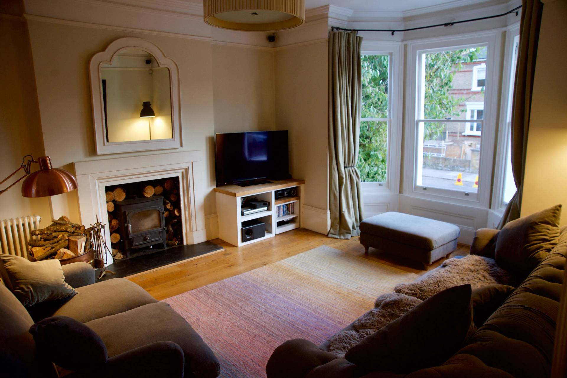 Victorian formal lounge with bay window light, fireplace hearth, and traditional ceiling coving, Love Locations TW1.