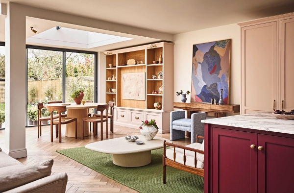 Open-plan living space transition showing an oak dining alcove, green rug, and coffee table layout, Love Locations SE21.