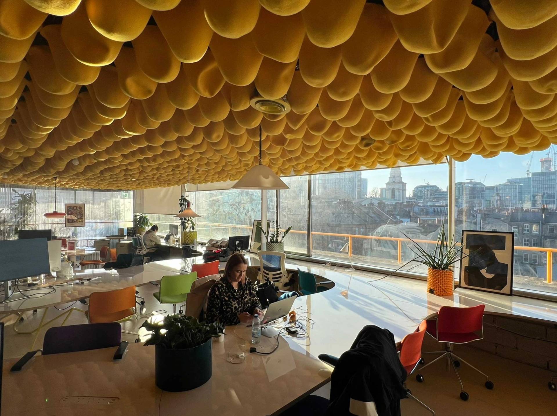 Stylish East London workspace with vibrant ceiling installation and lounge seating in Whitechapel – love locations
