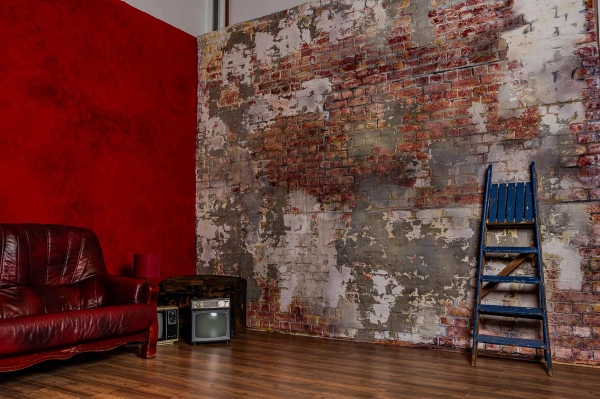 Industrial photography studio set featuring a weathered exposed brick wall set on dark timber floorboards, Love Locations N15.