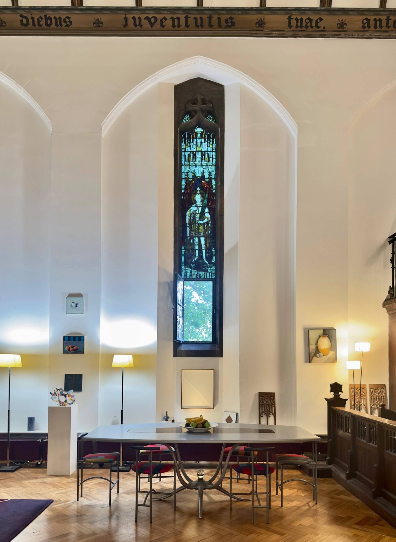 Soaring tall stained glass window casting natural light into a chapel nave shoot location in Oval SE5 via Love Locations.