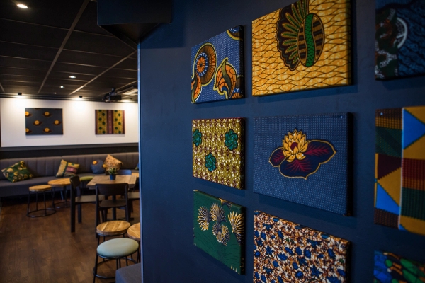 Close-up detail of patterned African textile art panels displayed on a deep navy blue wall at The Ritzy SW2, ideal for creative cultural brand campaigns, Love Locations.