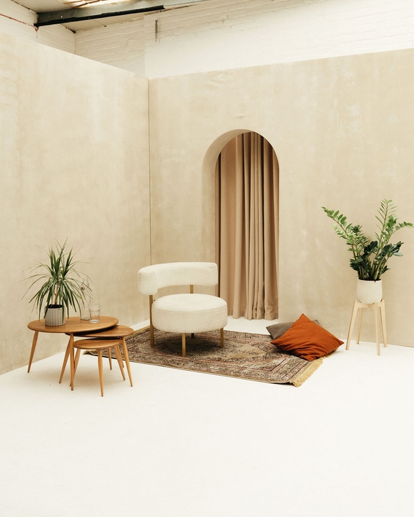Brushed plaster arched wall with soft curtain styled as an elegant event space at Brixton Warehouse Love Locations.