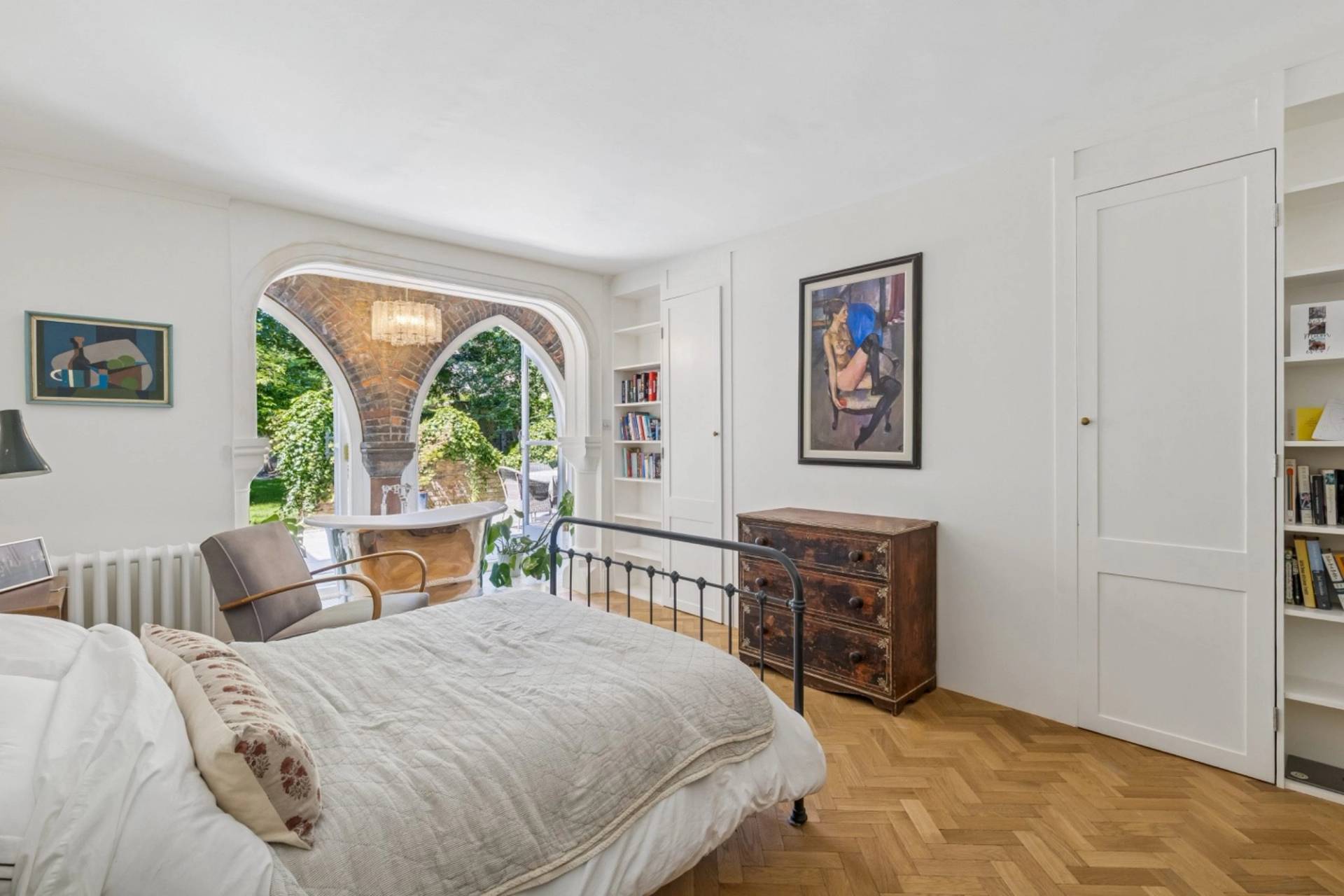 Bedroom interior with view toward gothic arched window nook in Hampstead from Love Locations.