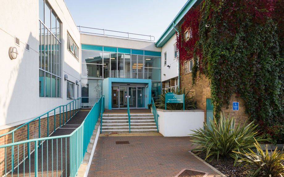 Contemporary secondary school entrance building facade and steps with teal handrails in Barnet N12 by Love Locations.