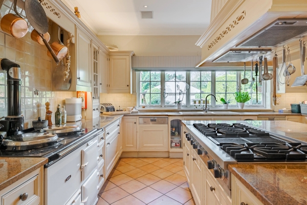 Large sash windows overlooking expansive garden lawns.