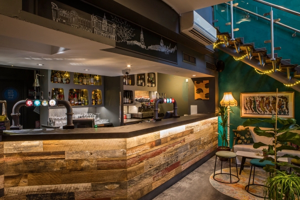 Rustic reclaimed timber bar counter and illuminated optics display inside the cafe-bar at The Ritzy in Brixton, South London SW16/SW2, perfect for beverage advertising via Love Locations.