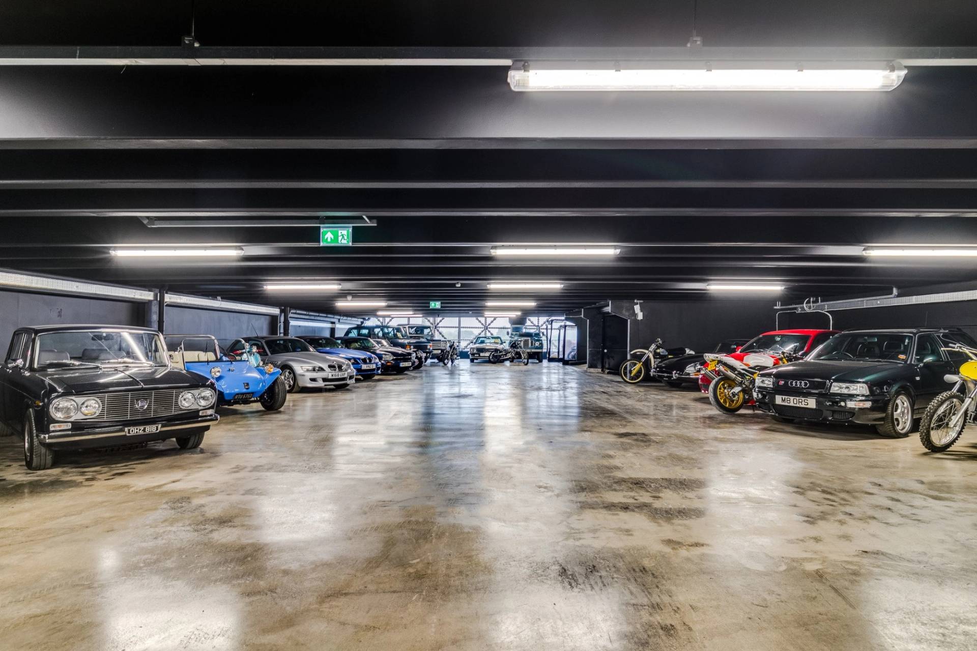 Diverse collection of classic and sports cars inside a Brentford TW8 location venue through Love Locations.