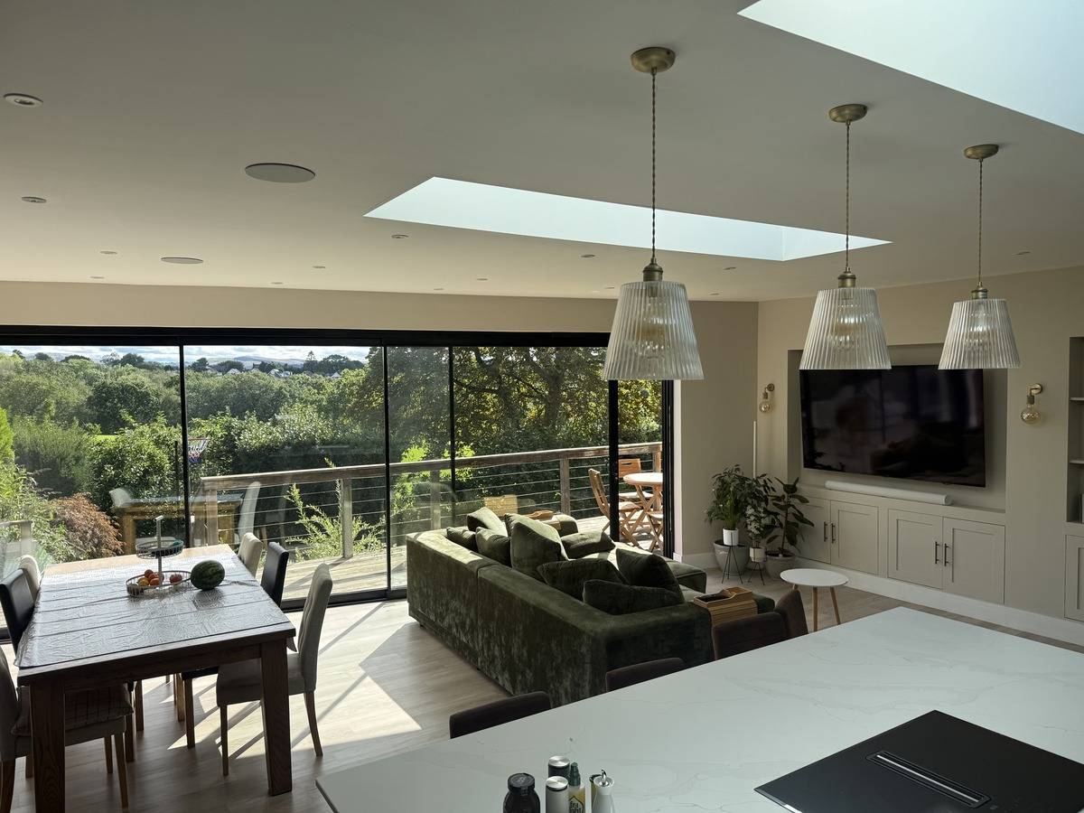 Contemporary kitchen and dining room film location in Stockport SK6 through Love Locations, highlighting natural light from skylights and expansive garden views.