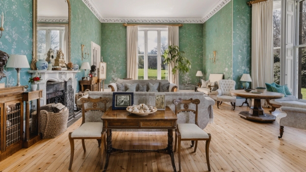 Grand castle drawing room with sage green wallpaper, sash windows, and antique furniture in Fife, Love Locations KY15.