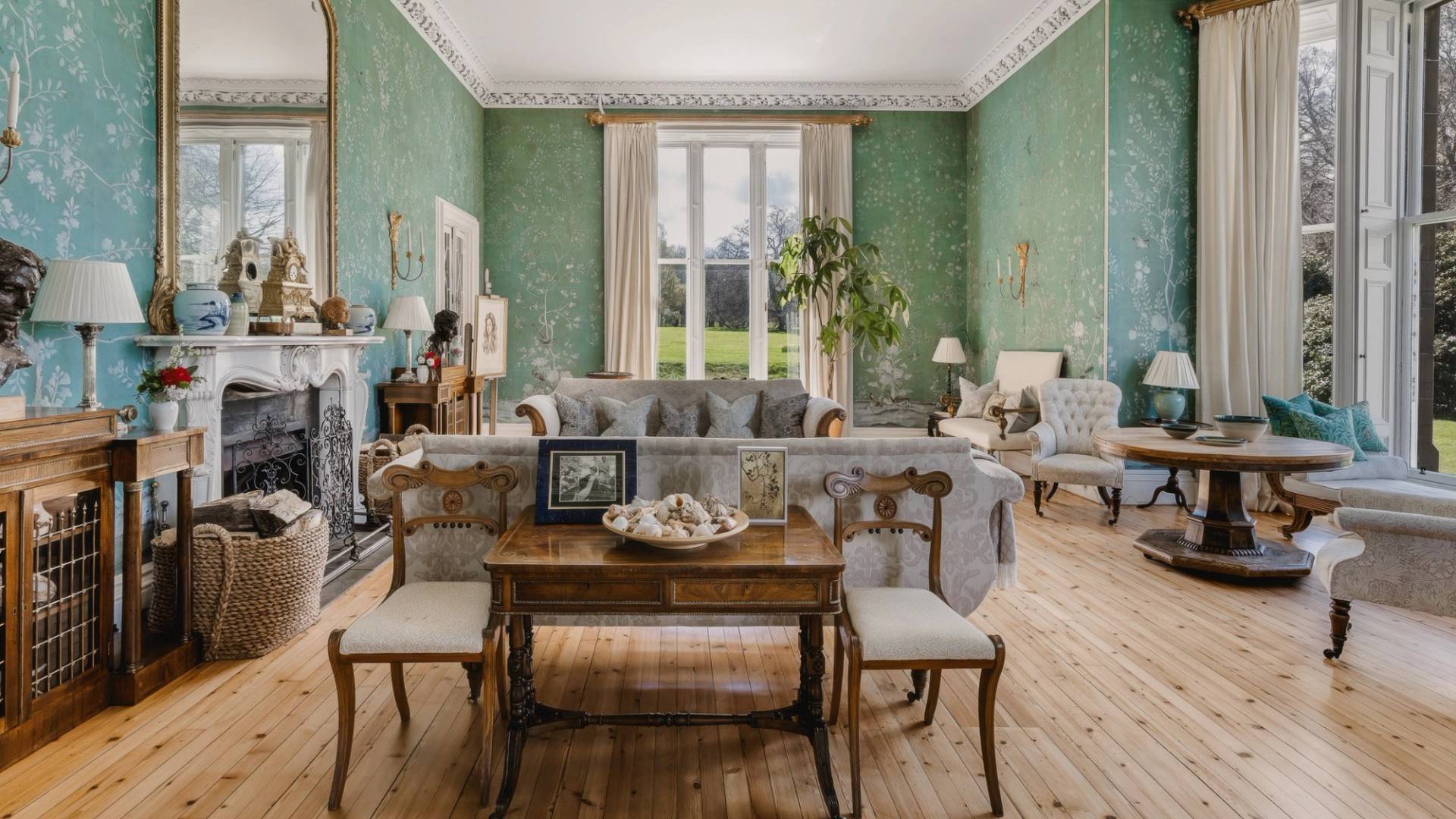 Grand castle drawing room with sage green wallpaper, sash windows, and antique furniture in Fife, Love Locations KY15.
