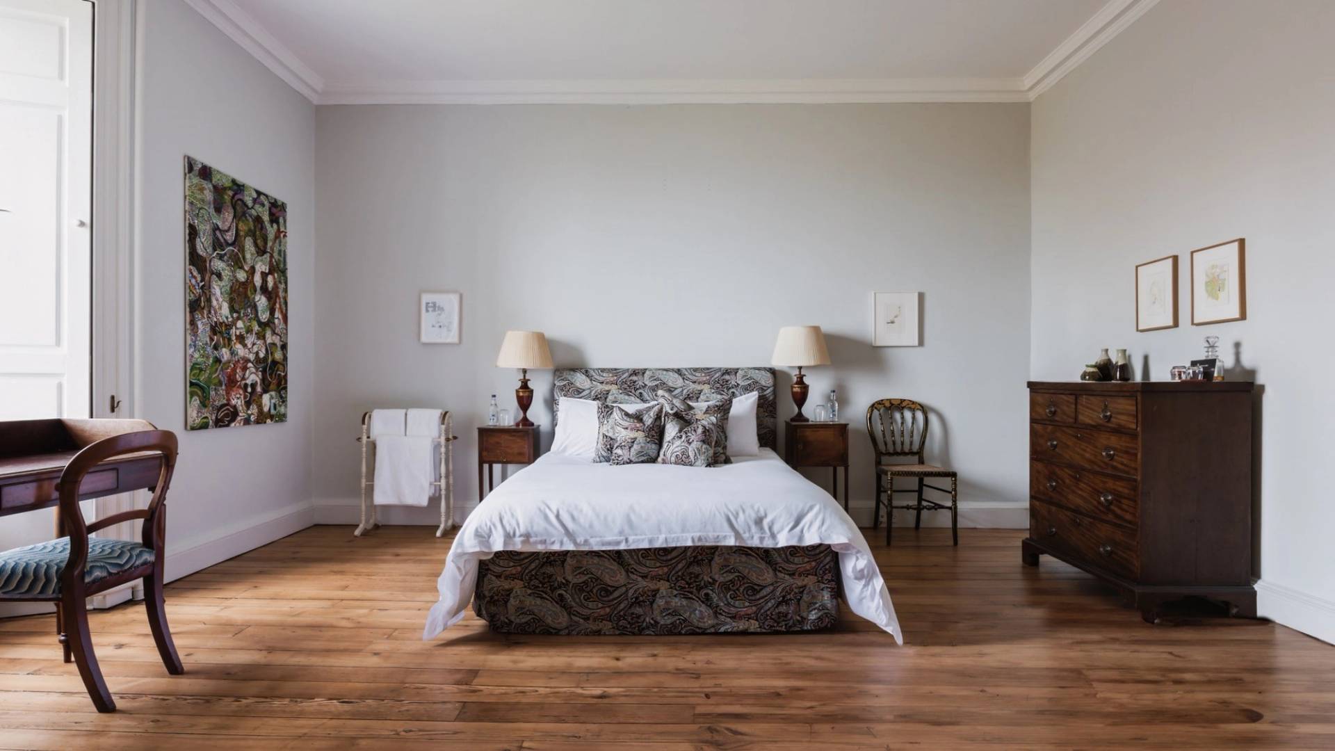 Minimalist guest bedroom with a king-size bed, neutral grey walls, and simple wood furnishings, Love Locations KY15.