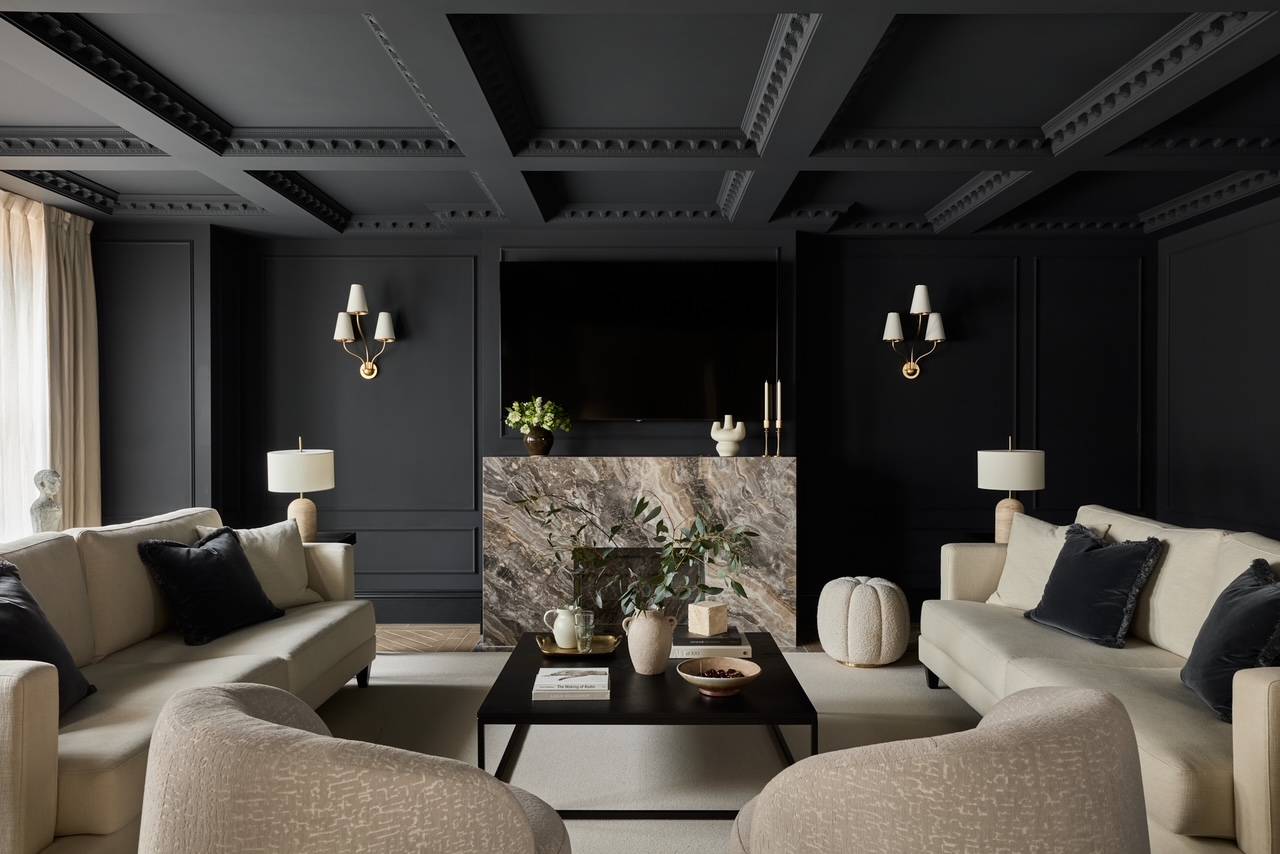 Moody dark-panelled living room featuring a striking marble fireplace hearth and contrasting neutral sofas, perfect for dramatic TV series and film sets, Love Locations WD23.