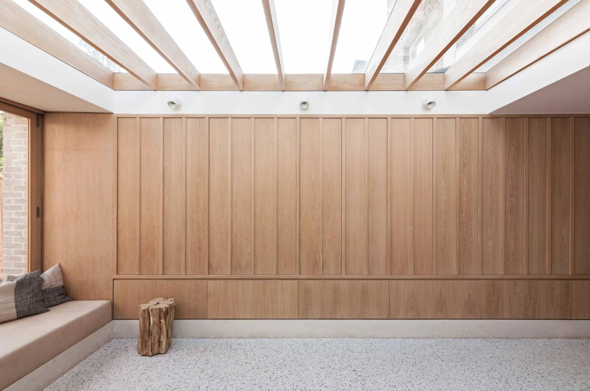 Minimalist room interior with light oak wall cladding and exposed roof joists in Hackney London N16 available via Love Locations.