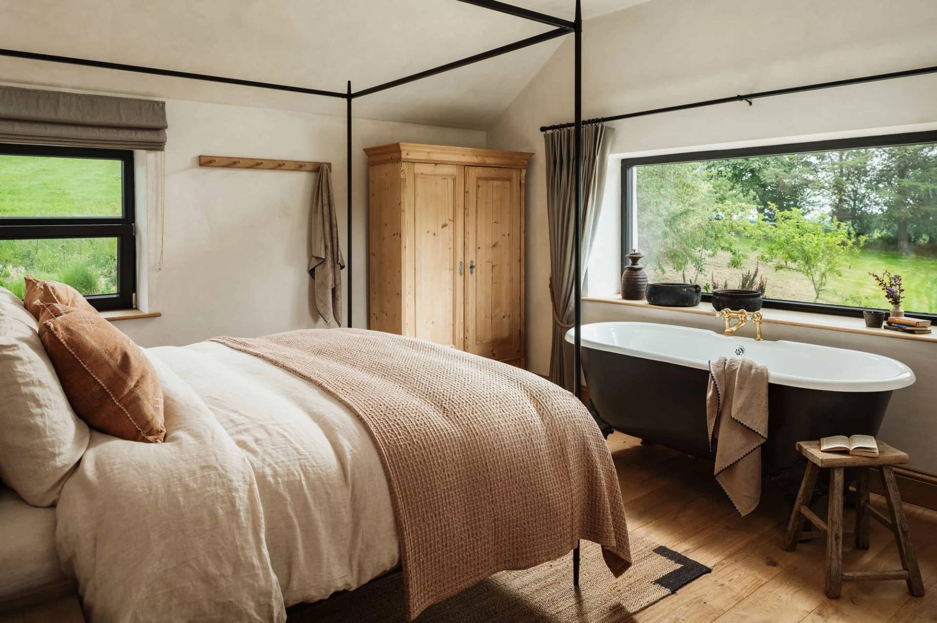Luxury bedroom photoshoot setting in Castleblayney County Monaghan Ireland via Love Locations, showcasing a four-poster bed, freestanding bathtub, and wooden wardrobe.