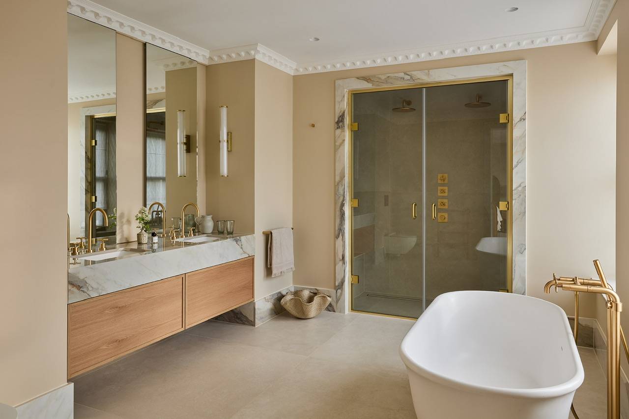 Spacious master bathroom location in Hertfordshire featuring a floating oak double vanity and a freestanding luxury soaking tub, perfect for wellness brand commercials, Love Locations.