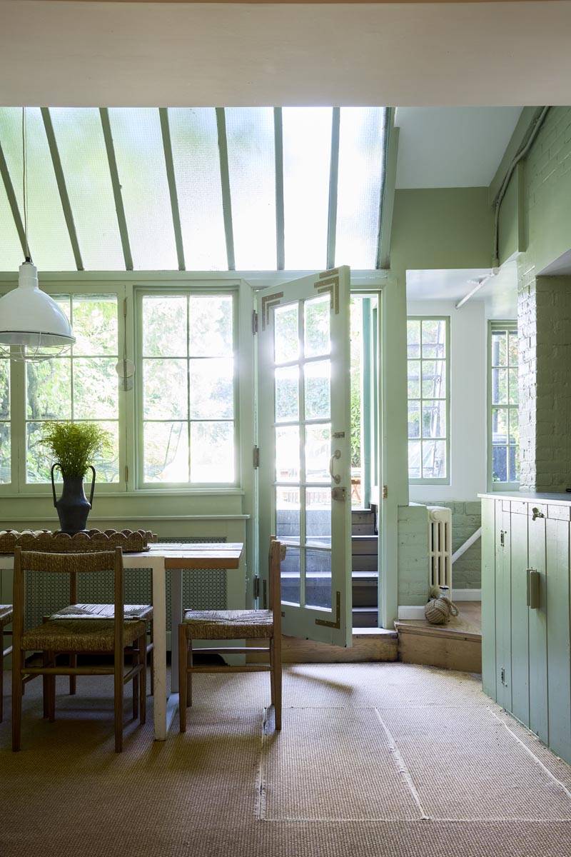 Mint green conservatory dining room film location with sloped glass greenhouse roof and French doors in Manhattan NY 10014 by Love Locations.