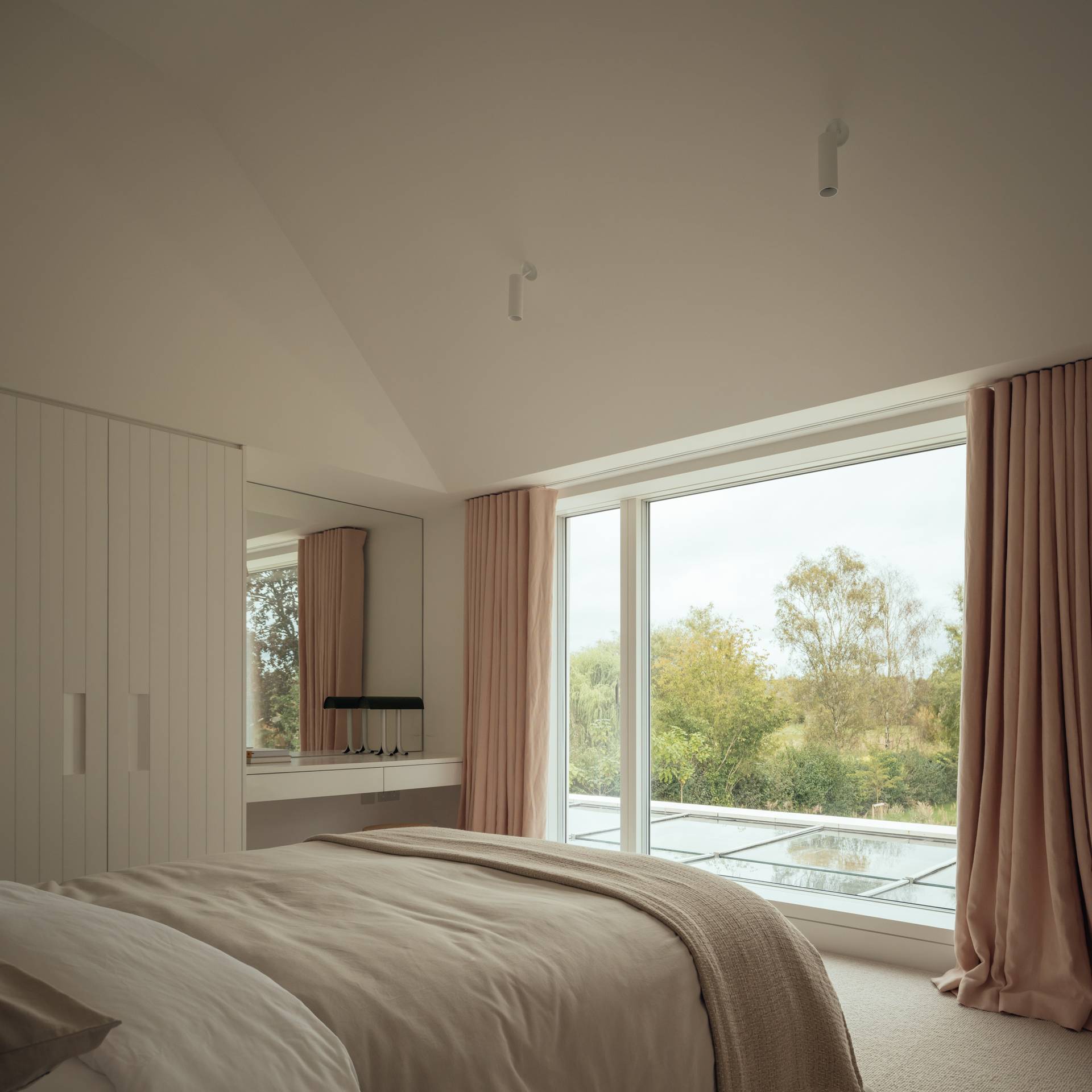Contemporary bedroom corner with large picture windows framing riverside views, perfect for peaceful lifestyle digital content, Love Locations.