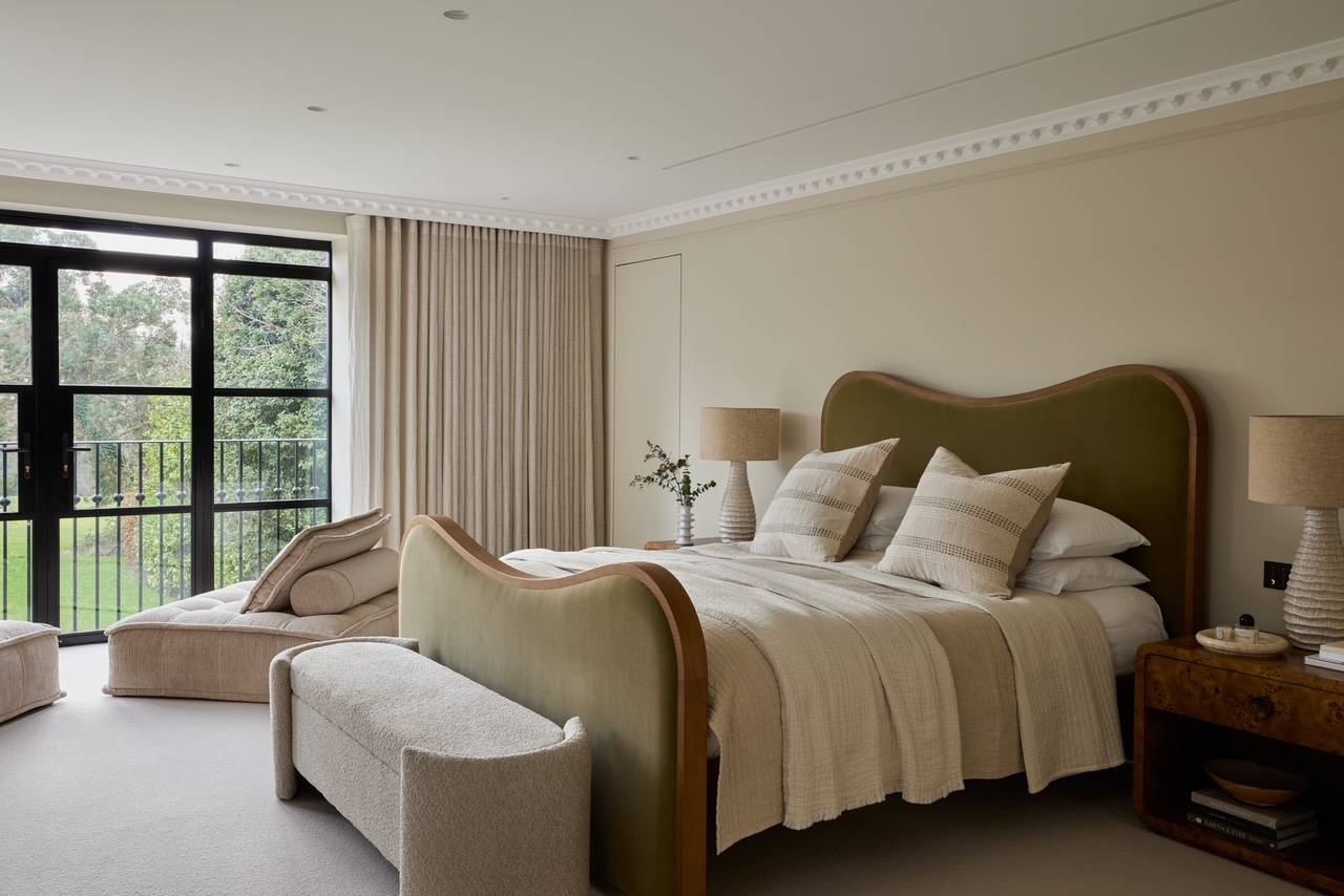 Serene master bedroom shoot location featuring an olive green velvet headboard, linen bedding, and scenic window views, ideal for premium mattress advertising, Love Locations WD23.