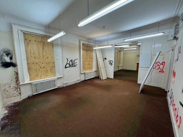 Distressed interior shoot space featuring urban graffiti walls and industrial strip lighting fixtures, managed by Love Locations.