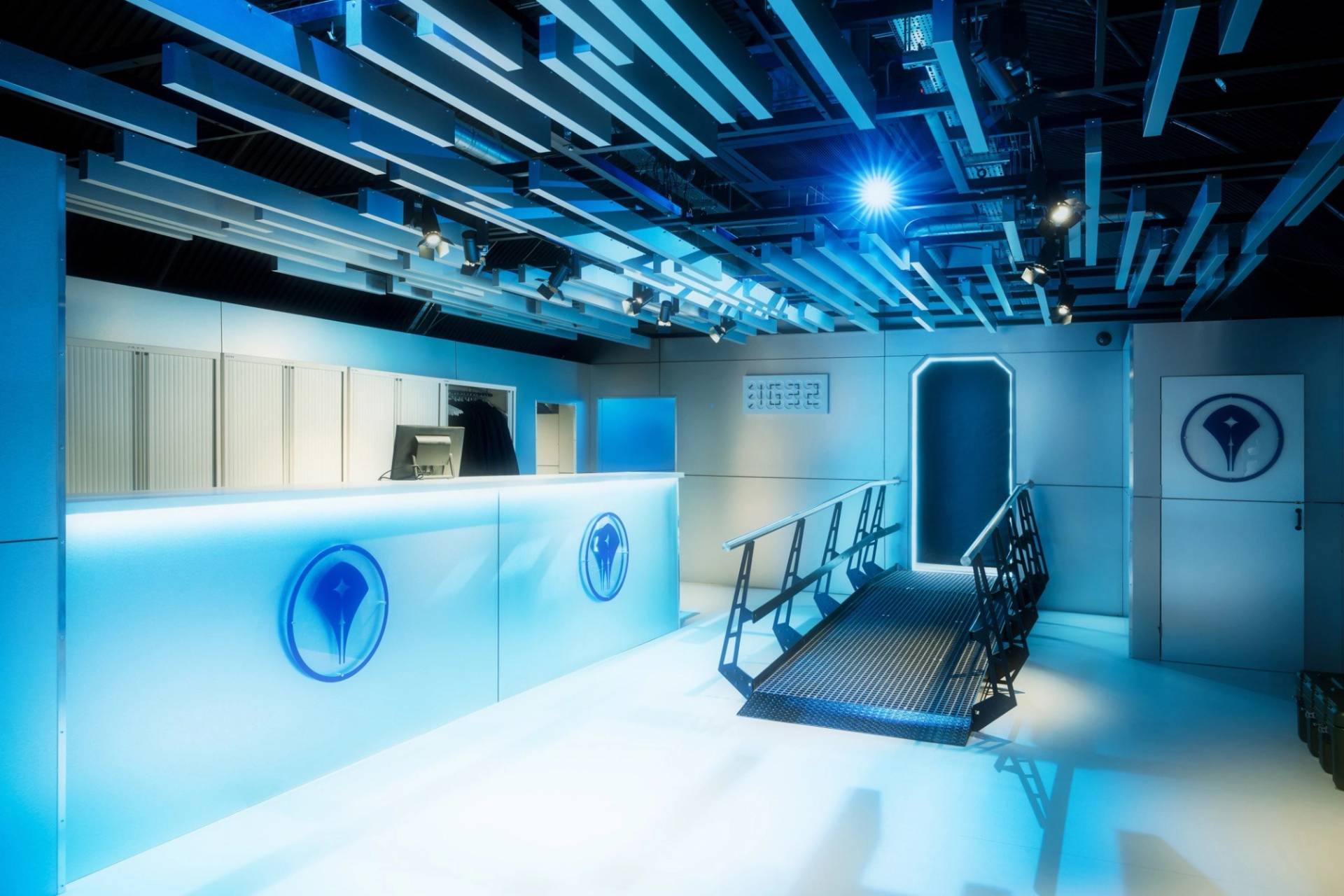 Futuristic blue illuminated reception desk or spaceship terminal deck for corporate events and filming, via Love Locations.