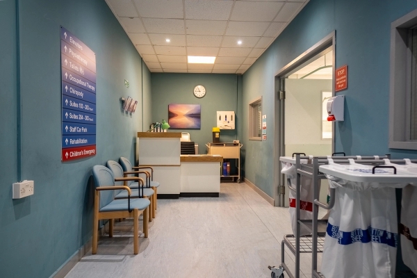 Authentic hospital corridor shoot location with reception desk, blue walls, waiting chairs, and linoleum floors in Hayes, Love Locations UB4.