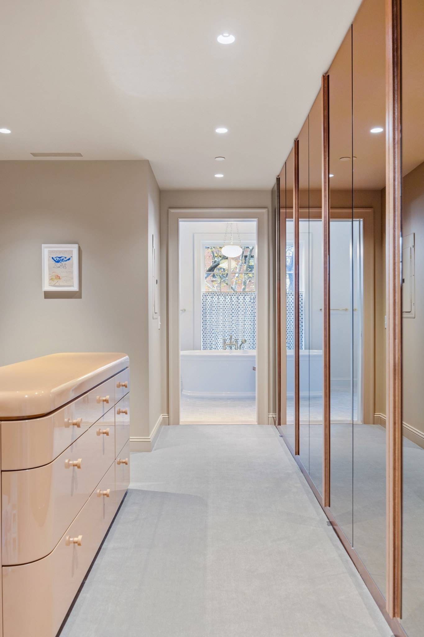Modern minimalist dressing hallway and mirrored closet shoot space in a Boerum Hill townhouse from Love Locations, with soft beige walls and glass partitions.