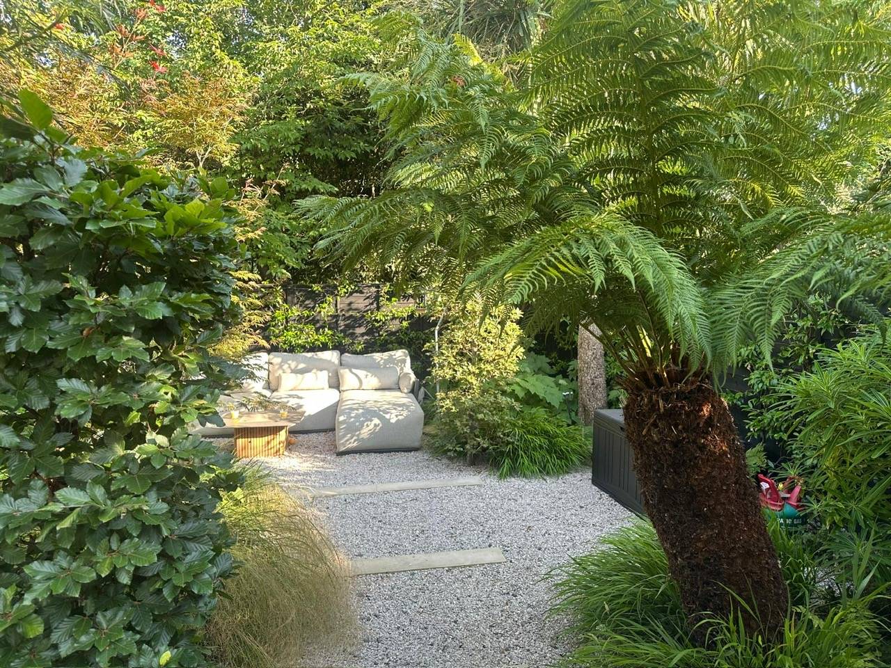 Sunlit internal lightwell courtyard feature with tropical foliage in a modern location home in Hackney N16 via Love Locations.