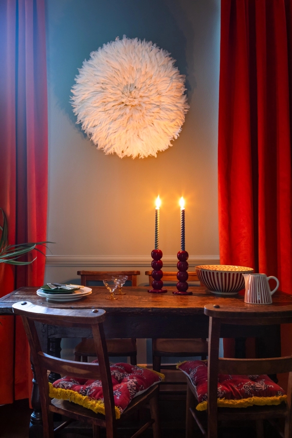 Moody dining room setup with dark walls, red drapes, and candlelight, available for film and photography in Westminster SW1V via Love Locations.