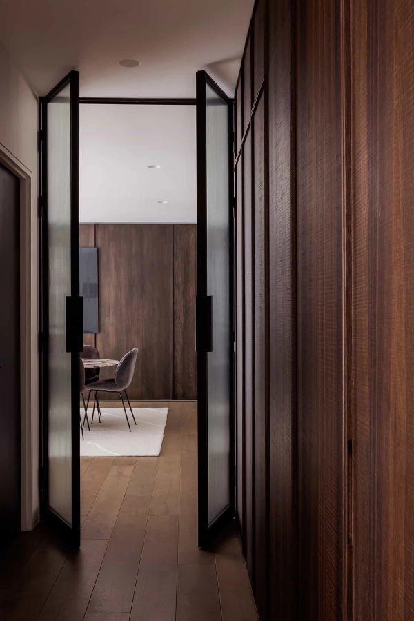 Architectural interior view through sliding wooden doors into a luxury dining setup, available via Love Locations, BR7.