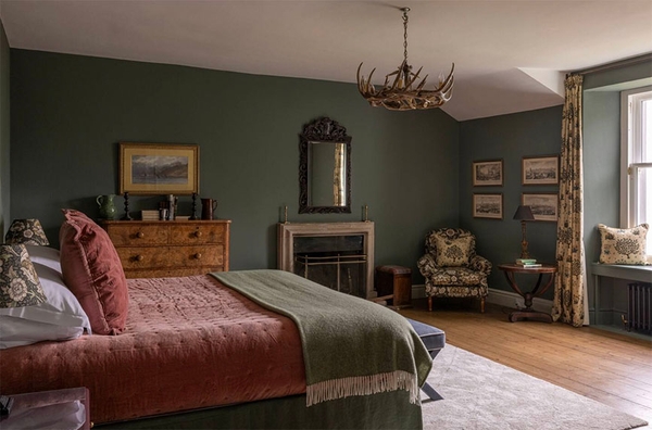 Glenstriven main bedroom with four-poster bed, fireplace, oak floor and elegant country house décor.