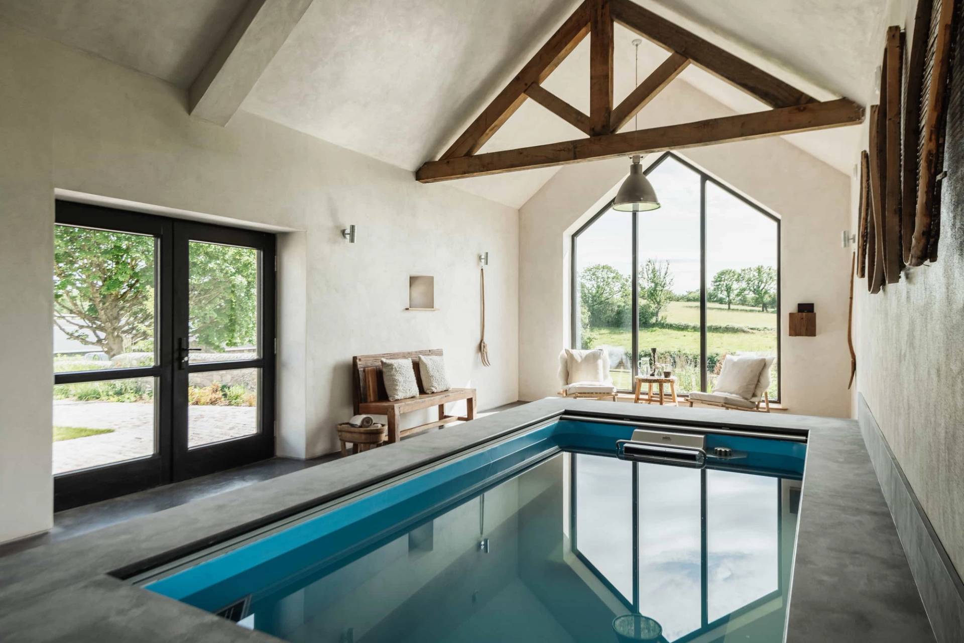 Luxury indoor pool shoot venue in Castleblayney County Monaghan Ireland through Love Locations, showing dark water reflections, stone surrounds, and exposed wooden beams.