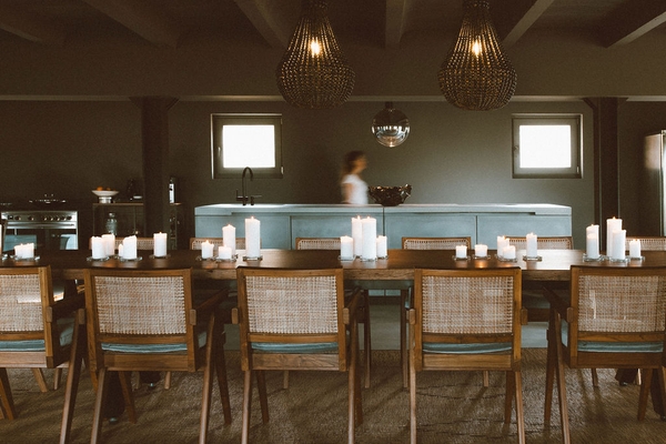 Rustic luxury dining room featuring woven pendant lights, long wooden table, and woven dining chairs, Love Locations 07630.