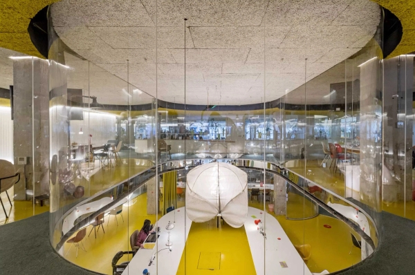 Contemporary yellow event space with audience seating and circular skylight in Whitechapel London E1 – love locations