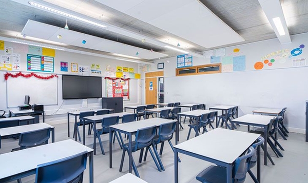 Love Locations modern school classroom location London SE2: Neat institutional learning room with suspended ceiling acoustics and ample natural light, optimized for children's brand commercials.